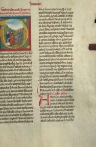 Illuminated medieval manuscript page with a gilded initial depicting three robed figures and dense Latin columns, suitable for The Ultimate Guide to Understanding the Bible for Kids: Parts and Meanings Explained.