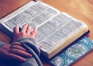 Open annotated Bible with a hand on the page showing Why Reina Valera 1960 Bible is the Ultimate Guide for Christians