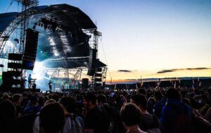 Outdoor concert stage at sunset with a large crowd and illuminated rigging, Easy Steps to Install RVR Bible in EasyWorship 2009